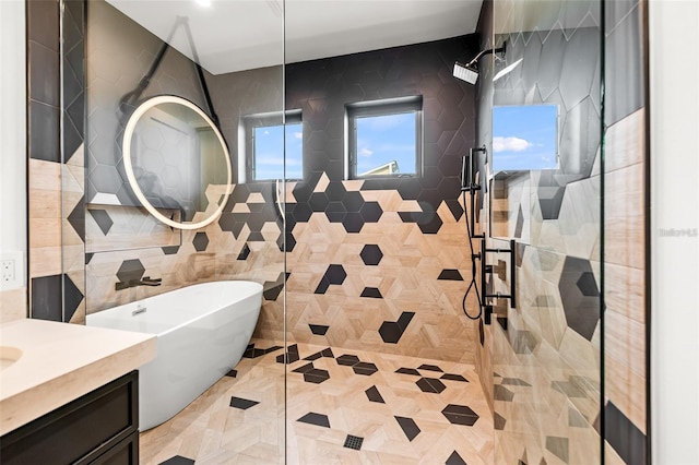 bathroom featuring vanity, tile walls, and shower with separate bathtub