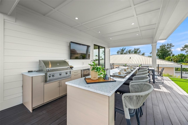 wooden terrace with area for grilling and a grill