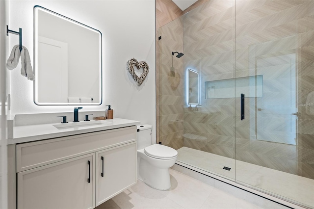 bathroom with tile patterned flooring, vanity, toilet, and a shower with door