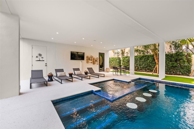 view of swimming pool featuring an in ground hot tub and a patio area