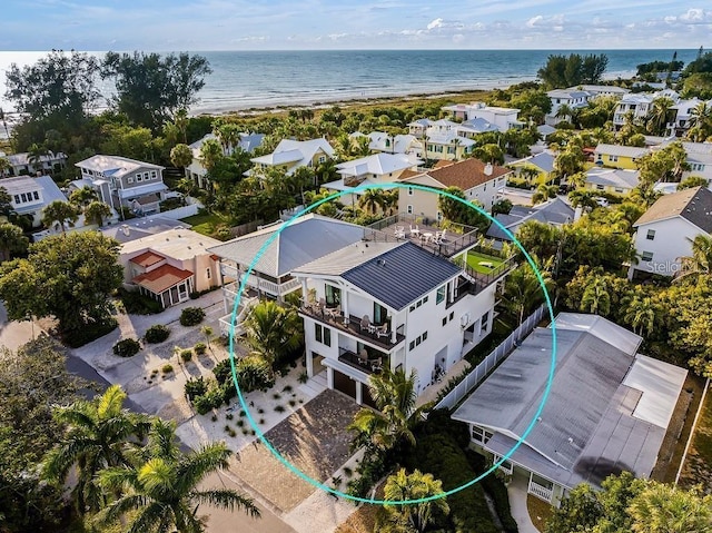 birds eye view of property with a water view and a view of the beach