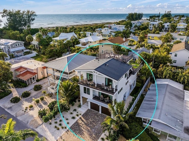 drone / aerial view with a water view and a beach view