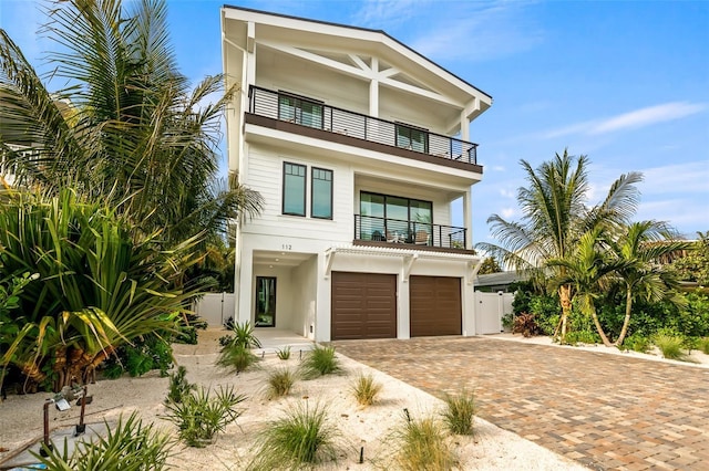 view of front of home with a garage and a balcony