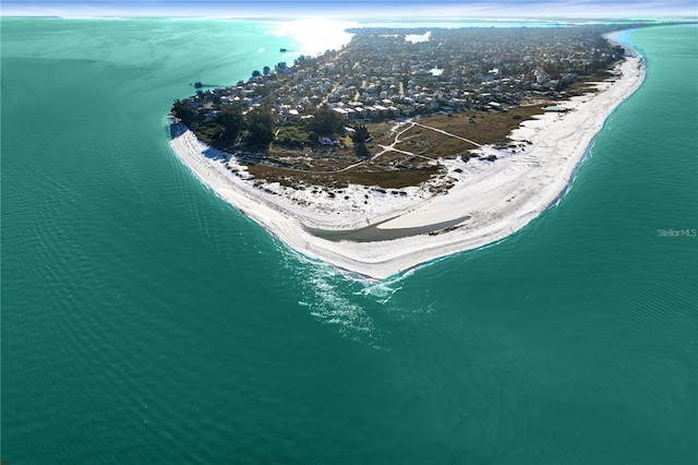 birds eye view of property featuring a water view and a beach view