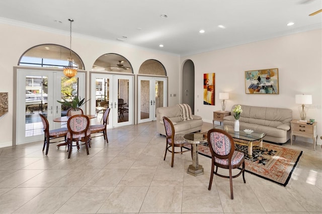 living room with french doors, light tile patterned flooring, an inviting chandelier, and ornamental molding