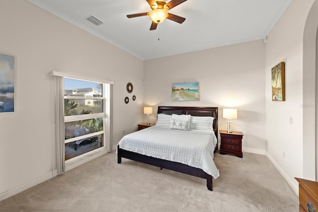 carpeted bedroom with ceiling fan and ornamental molding