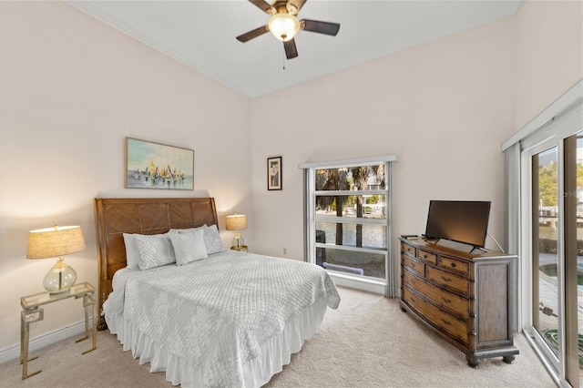 bedroom featuring light colored carpet and ceiling fan