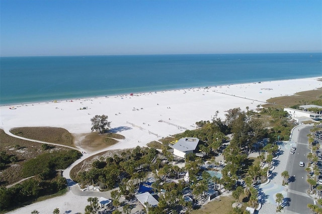 bird's eye view with a water view and a beach view