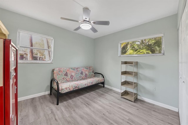 sitting room featuring ceiling fan and light wood-type flooring