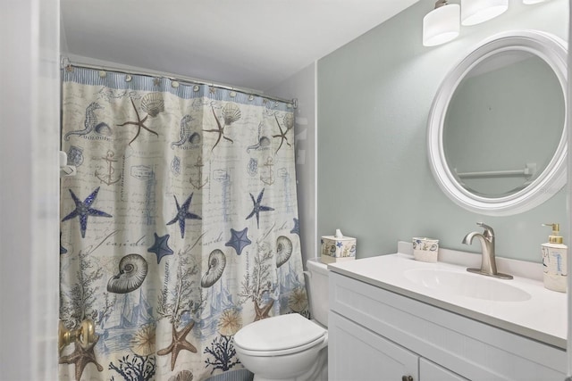 bathroom featuring vanity, toilet, and walk in shower