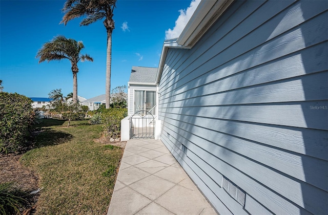 view of side of property with a lawn