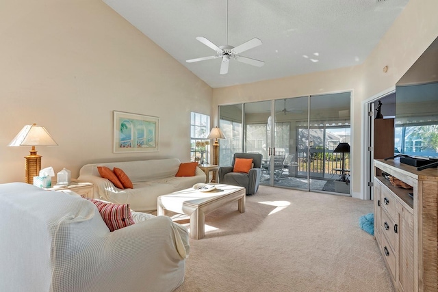 living room featuring a wealth of natural light, light colored carpet, high vaulted ceiling, and ceiling fan