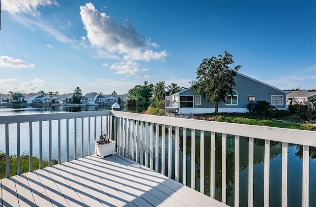 wooden terrace featuring a water view