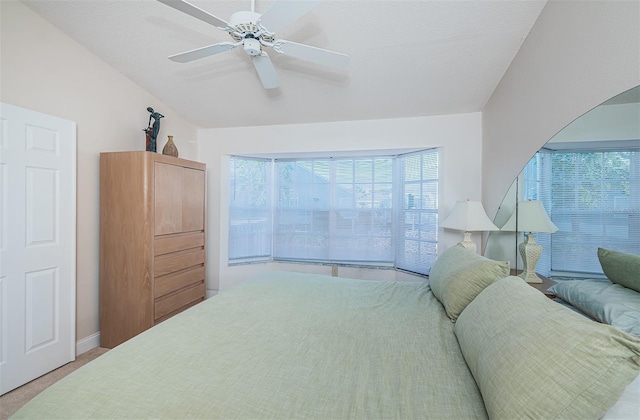 bedroom with ceiling fan and a textured ceiling