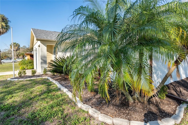 view of side of property featuring a yard