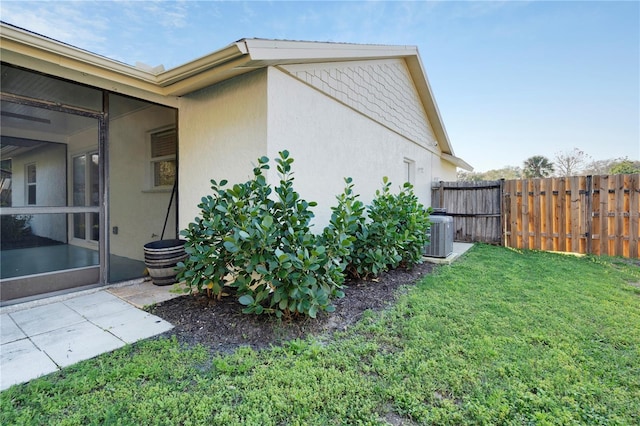 view of home's exterior with a yard and central air condition unit