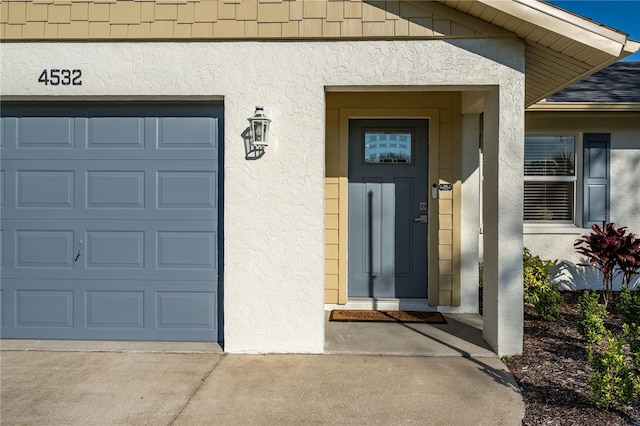 view of exterior entry with a garage