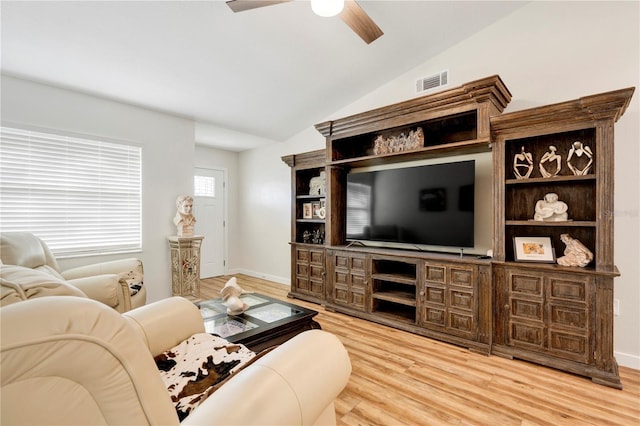 living room featuring hardwood / wood-style floors, ceiling fan, and vaulted ceiling