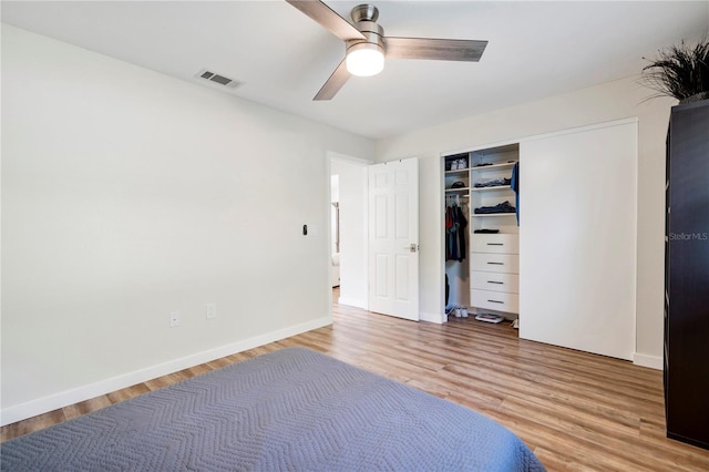 unfurnished bedroom featuring wood-type flooring, a closet, and ceiling fan