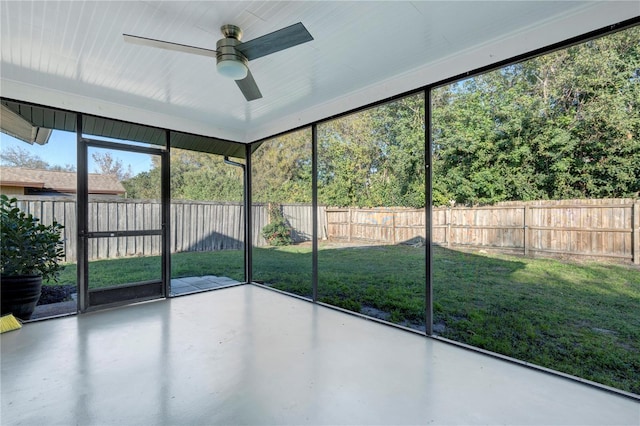 unfurnished sunroom featuring ceiling fan