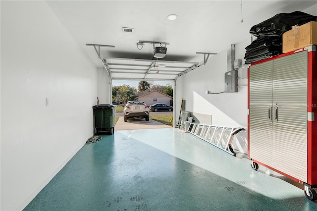 garage with electric panel and a garage door opener