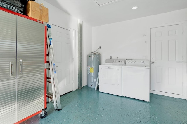 clothes washing area with electric water heater and washer and dryer