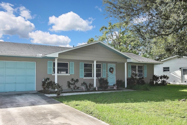 ranch-style home featuring a garage and a front yard