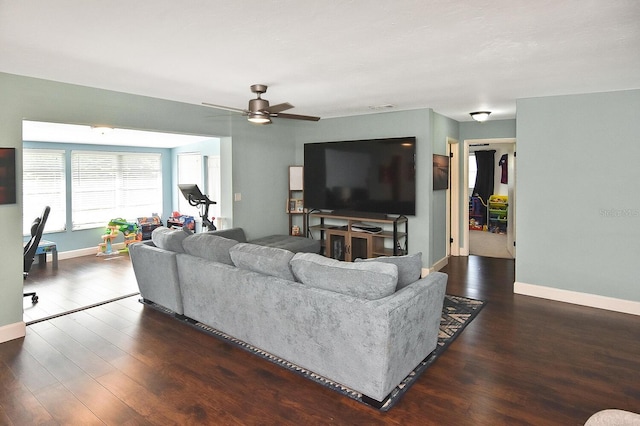 living room with ceiling fan and dark hardwood / wood-style flooring