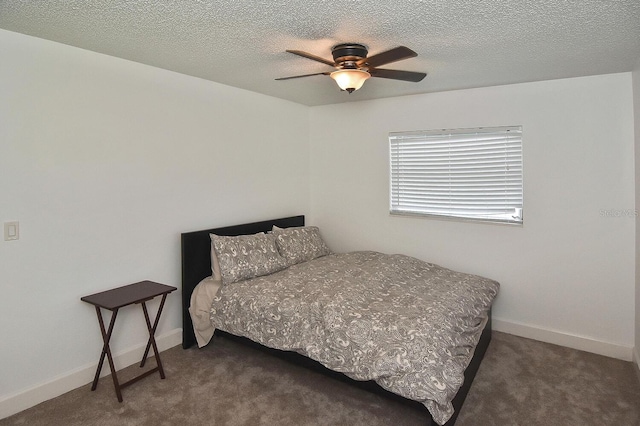 carpeted bedroom featuring a textured ceiling and ceiling fan