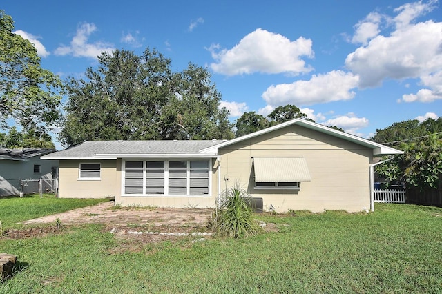 back of property featuring a yard