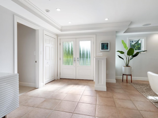 entrance foyer featuring french doors, plenty of natural light, and ornamental molding