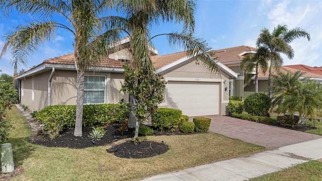 view of front of home with a garage and a front lawn