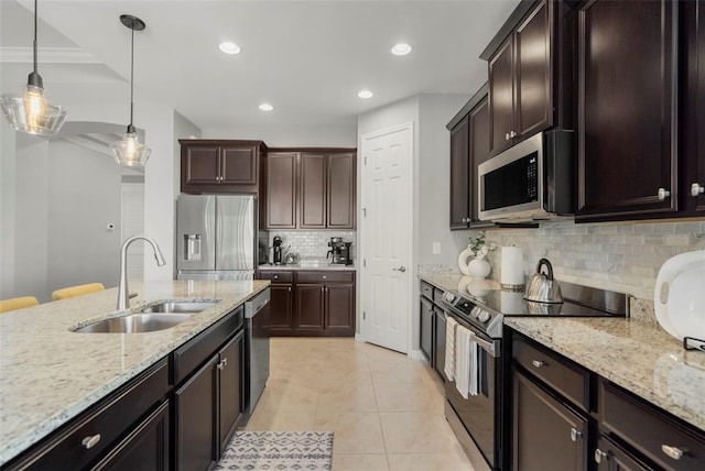 kitchen featuring sink, stainless steel appliances, decorative light fixtures, decorative backsplash, and light tile patterned flooring