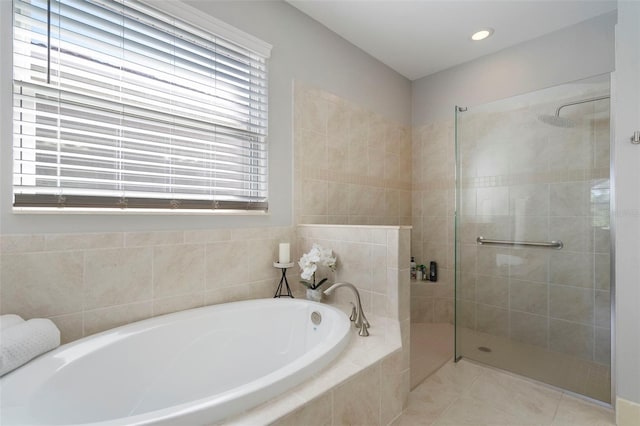 bathroom with separate shower and tub, a wealth of natural light, and tile patterned floors