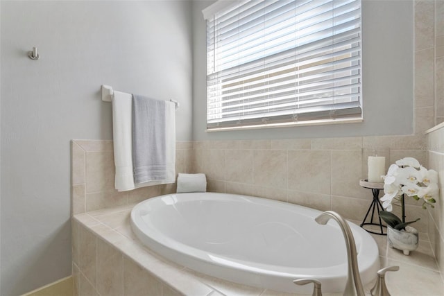 bathroom with a relaxing tiled tub