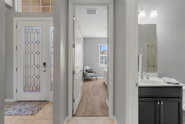 tiled entryway featuring sink