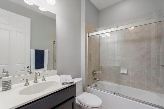 full bathroom with vanity, toilet, and enclosed tub / shower combo