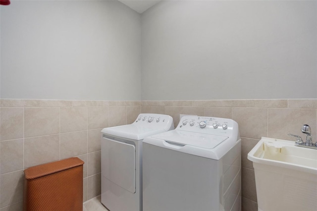 laundry room featuring washing machine and dryer and sink