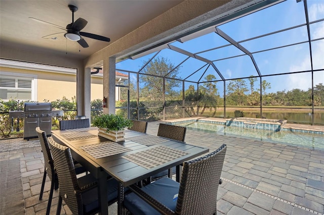 view of patio with a lanai, a grill, ceiling fan, and a swimming pool with hot tub