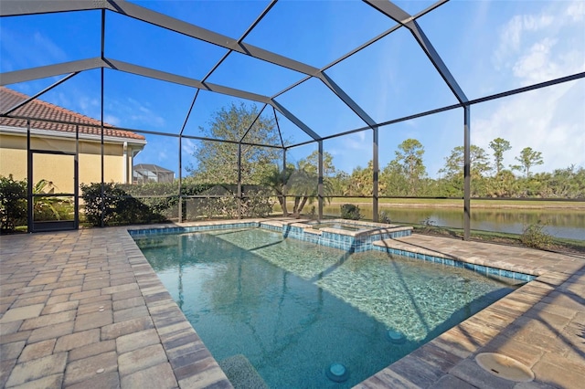 view of swimming pool with an in ground hot tub, a water view, glass enclosure, and a patio area