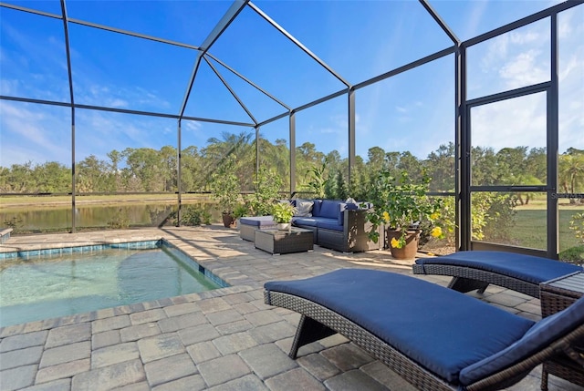 view of pool featuring a patio area, an outdoor living space, a water view, and glass enclosure