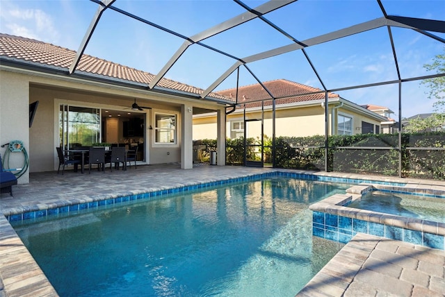 view of pool featuring a lanai, ceiling fan, a patio area, and an in ground hot tub