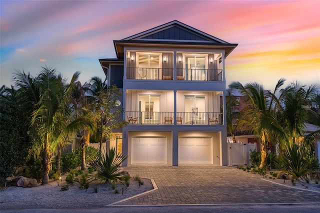 view of front facade featuring a balcony and a garage