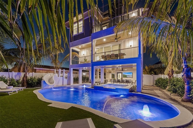 view of swimming pool with an in ground hot tub, a patio, and a water slide