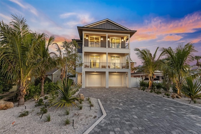 beach home with a balcony and a garage