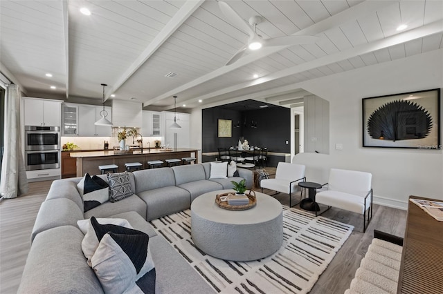 living room with hardwood / wood-style flooring, beam ceiling, and wood ceiling