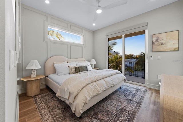 bedroom with access to exterior, ceiling fan, and hardwood / wood-style flooring