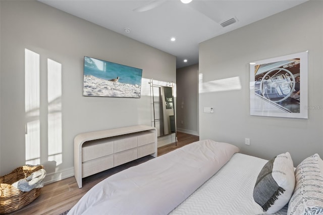 bedroom with hardwood / wood-style floors and ceiling fan