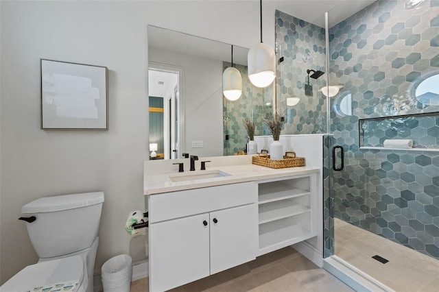 bathroom featuring vanity, toilet, and an enclosed shower