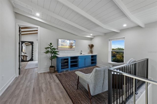 living room with sink, beverage cooler, lofted ceiling with beams, wood ceiling, and light wood-type flooring